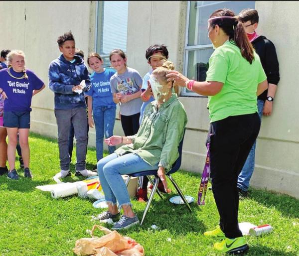 Intermediate students serve pies in the face
