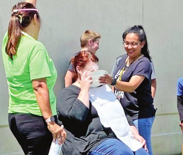 Intermediate students serve pies in the face