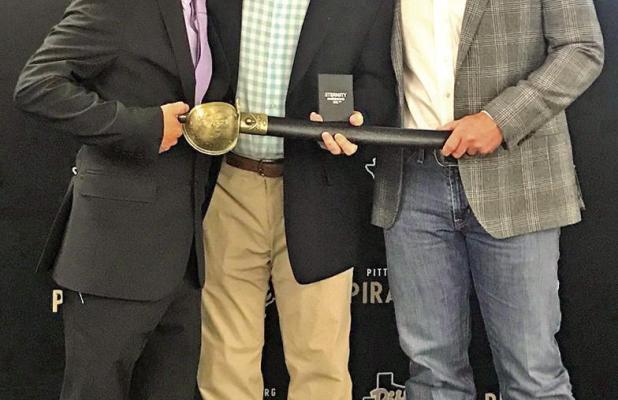 Assistant Athletic Director, John Chatham, Pittsburg ISD Superintendent, retiring, Terry Waldrep, and Athletic Director John Huffstetler. They gave him a sword inscribed as “Mr Wladrep, in all ways a Pirate”, and an inscribed pocket watch.