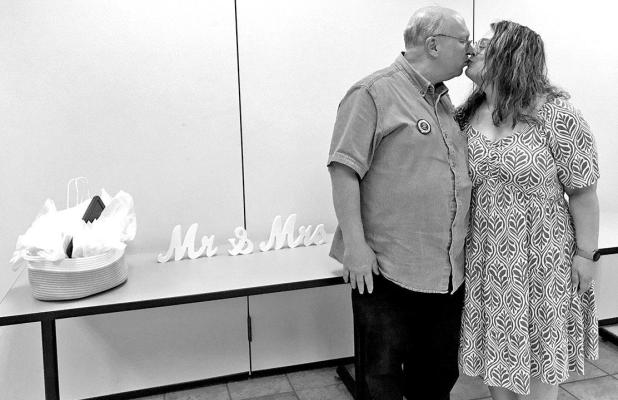 Lion Treasurer Charlie Wilson kisses fiancee Laura Rowley at surprise gathering