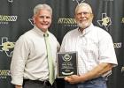 Ricky Parker, retiring from the school board, was presented with a plaque thanking him for 15 years of service on the board. GAZETTE PHOTO / ELIZABETH LANNING Parker retiring from school board