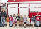 From left to right: Fire Marshal Wesley Kizer, Jakob Rosewell, Fire Chief Laura Keon, Lucia Rodriguez-Villeda, Brooklyn Anderson, Nita Long, Braylen Dube, Charleigh Brittain, Kyler Herring, Aevyn Mostyn, Everado Martinez, Daniel Perez, Mallory Valdelamar, Flashy ride to a cool treat for some hot kids