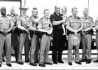 Texas Department of Public Safety troopers stand with DPS Sgt. Michael Sparks, center, who is holding his granddaughter, Abby Stilwell, at his retirement reception May 23. GAZETTE PHOTO / ELLIS KNOX Article Image Alt Text