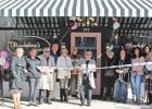 Salina Dollinger has the honor of cutting the ribbon after almost starting the project nearly four years ago. GAZETTE PHOTO / ELIZABETH LANNING New business welcomes the community