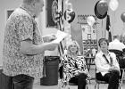 Mike Graham reads his poem, written especially for the occasion, for Jackie and Dotsy. GAZETTE PHOTO / ELIZABETH LANNING Dynamic Duo