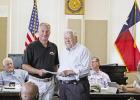 Ashley Willson (left) presents Ned Muse (right) with the funds to erect a historical marker to the memory of Carroll Shelby. GAZETTE PHOTO / ELIZABETH LANNING Commissioners accept donation for Shelby historical marker