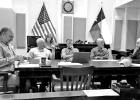 Commissioners Steve Lindley, Perry Weeks, Tommy Rozell, and Jed Hefner discuss points made by County Judge A J Mason.
