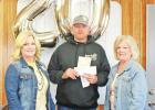 Curtis Young is presented with a token of appreciation by Billie Jo Arnold (pictured left) and Rhynn McMinn (pictured right). COURTESY PHOTOS Twenty years of commitment
