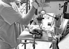 Pastor Jeff Dungan works the drill press crafting parts for a mobility cart. Pittsburg volunteers build for Mobility Worldwide