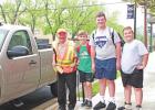 A few of James Threadgill’s kids pose with their friend after presenting him with the keys to his new truck. GAZETTE PHOTO / ELIZABETH LANNING All good stories should have a happy ending