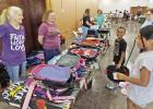 Liza and Frances Cravey assist the kids as they choose their favorite backpack. Local businesses are such a blessing for our kids