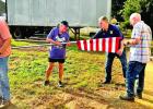 Committee members preparing flags for delivery and setup.