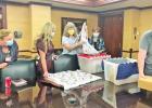 Janet Kats (center) shows the handmade children’s blankets she donated to UT Health Tyler to Robin Davis (from left), clinical/operational manager for pediatrics, Chief Nursing Officer Lecia Bowman and CEO Vicki Briggs, while Greg Kats (far right) unpac Couple donates creations to help