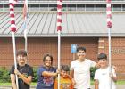 This senior Interact Club member managed to talk her friends and little brother into helping her take the flags down around the courthouse, FUMC, school admin building and surrounding areas. GAZETTE PHOTO / ELIZABETH LANNING Interacting in the community with a purpose