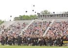GAZETTE PHOTO / ELIZABETH LANNING The Class of 2023 performs the traditional celebration of tossing their caps. This started in 1912 at the U.S. Naval Academy when the class tossed their unneeded midshipmen hats aside to make way for the new hats that cam Class of 2023 turns the tassel