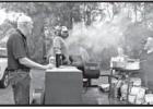 Sabin Warrick, with his son John Wayne Warrick, and cheerleader Woody Ray, prepare special scampi sauce and grillers for the feast Sabin Warrick, with his son John Wayne Warrick, and cheerleader Woody Ray, prepare special scampi sauce and grillers for the feast