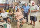 Front row--Left to right: Cheryl Woodard, Kathy McCullough, Paul Woodard. Back Row: Ken Gralaum and Ed (Bryan shop managers) COURTESY PHOTO Pittsburg volunteers build for Mobility Worldwide