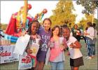 These friends spent an evening at Broach Park enjoying the National Night Out in Pittsburg. GAZETTE PHOTOS / ELIZABETH LANNING Celebrating our EMS