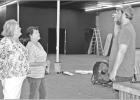 GAZETTE PHOTO / LYNDA STRINGER Renae Fogerty, left, and Alice Pollard, center, discuss the progress of renovations inside their Bleu Hen Crossing Venue on Rusk Street with Byron Aldredge, owner of Anvil Brewing, who is the contractor on the project. Article Image Alt Text