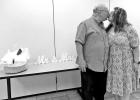 Lion Treasurer Charlie Wilson kisses fiancee Laura Rowley at surprise gathering