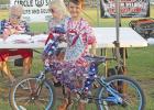 Chandler Schmidt, 7 years old, spent several hours on his bike, decorating it with stars and spangles. He also added some pop cans as a jingling train, or caboose, to his bike. GAZETTE PHOTOS / ELIZABETH LANNING Patriotic bikers