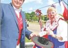 Chamber Board President James Wallace accepts a donation from “Sparkles the Clown,” who came to town to help save the Independence Day Blast. Article Image Alt Text