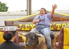 This young lady was a little concerned about that wild bull at first, but they became fast friends before the day was done. GAZETTE PHOTO / ELIZABETH LANNING Students enjoy special rodeo