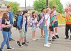 The students give Threadgill the money, keys, and paperwork in the middle of the crosswalk, and point out his vehicle across the road. GAZETTE PHOTO / ELIZABETH LANNING All good stories should have a happy ending