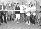 GAZETTE PHOTO / ELLIS KNOX Mayor David Abernathy, far left, and City Manager Clint Hardeman, far right, join family members, chamber volunteers, as well as city and county officials for a ribbon cutting at Be*YOU*tiful Salon. Owner Monica Penny invites ev Article Image Alt Text