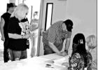 GAZETTE PHOTO / LYNDA STRINGER Pittsburg resident Jim Carrigo signs in to vote in the Pittsburg Mayoral election Saturday, May 4, while a line formed in the final hour of voting. Article Image Alt Text