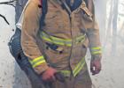 Fireman Logan operating the blower to create a boundary for the fire. GAZETTE PHOTO / ELIZABETH LANNING High winds and low wires equal fire