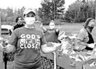 Rita George helps pack the boxes for the first-ever Camp County drive-thru food pantry. There were almost 400 families helped. COURTESY PHOTO