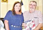 GAZETTE PHOTO / ELLIS KNOX Laurent and French pose for a photo after the book presentation at the Commissioners Court meeting July 31. Article Image Alt Text